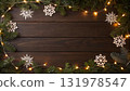 The image showcases a wooden background adorned with fir branches, snowflake ornaments, and warm fairy 131978547
