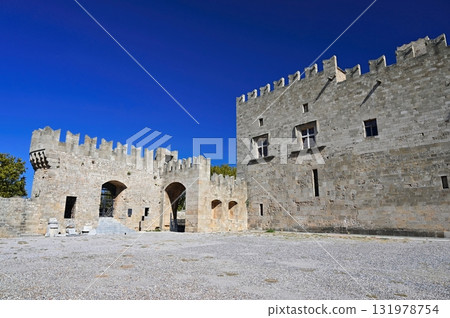 Beautiful old town of Rhodes on the Greek island of Rhodes. Beautiful historical architecture with castle, shops and cafes. Concept for travel and vacation. Beautiful old town of Rhodes on the Greek island of Rhodes. Beautiful historical architecture with castle, shops and cafes. Concept for travel and vacation. 131978754