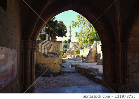 Beautiful old town of Rhodes on the Greek island of Rhodes. Beautiful historical architecture with castle, shops and cafes. Concept for travel and vacation. Beautiful old town of Rhodes on the Greek island of Rhodes. Beautiful historical architecture with castle, shops and cafes. Concept for travel and vacation. 131978755