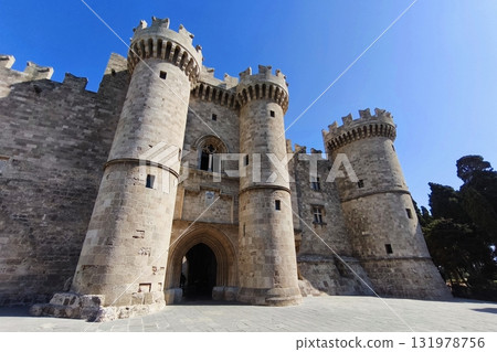 Beautiful old town of Rhodes on the Greek island of Rhodes. Beautiful historical architecture with castle, shops and cafes. Concept for travel and vacation. Beautiful old town of Rhodes on the Greek island of Rhodes. Beautiful historical architecture with castle, shops and cafes. Concept for travel and vacation. 131978756