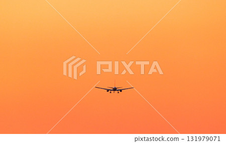 Orange evening sky and airplane Orange evening sky and airplane 131979071