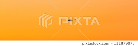 Orange evening sky and airplane Orange evening sky and airplane 131979073