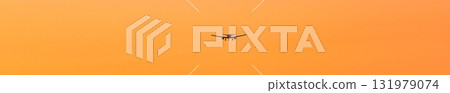 Orange evening sky and airplane 131979074