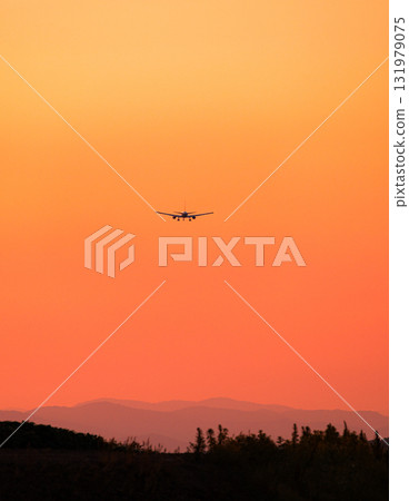 Orange evening sky and airplane Orange evening sky and airplane 131979075
