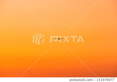Orange evening sky and airplane 131979077
