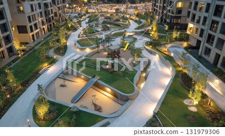 Stunning twilight view of a high-end residential complex's central courtyard. Features include thoughtfully designed landscaping, illuminated pedestrian paths, and unique, modern playgrounds Stunning twilight view of a high-end residential complex's central courtyard. Features include thoughtfully designed landscaping, illuminated pedestrian paths, and unique, modern playgrounds 131979306