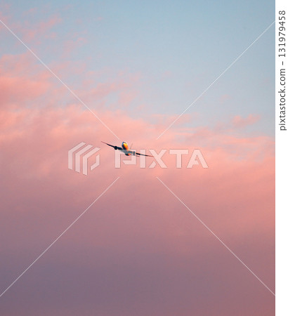 The red sky at dusk and a plane about to land The red sky at dusk and a plane about to land 131979458