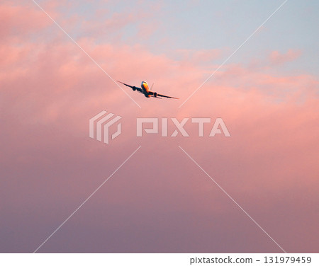 The red sky at dusk and a plane about to land The red sky at dusk and a plane about to land 131979459