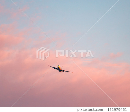 The red sky at dusk and a plane about to land 131979461