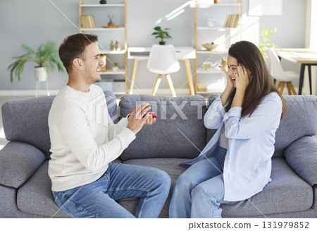 Marry me proposal, young man holding red box with marriage engagement ring for loving surprised Marry me proposal, young man holding red box with marriage engagement ring for loving surprised 131979852