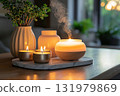 Burning candles and aroma diffuser on marble tray 131979869
