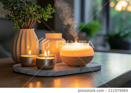 Burning candles and aroma diffuser on marble tray 131979869