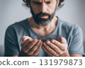 Worried man holding fallen hair in hands 131979873