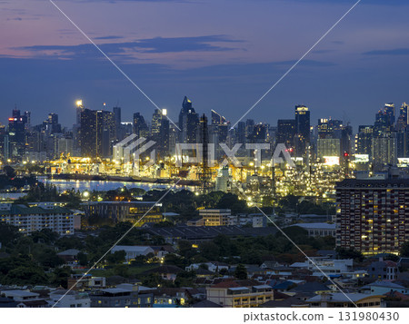 Night view of Bangkok, Thailand's skyscrapers and industrial areas along the Chao Phraya River 131980430