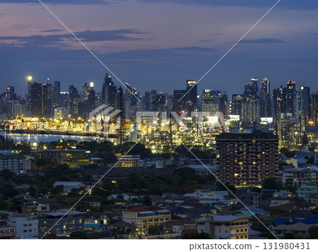Night view of Bangkok, Thailand's skyscrapers and industrial areas along the Chao Phraya River 131980431
