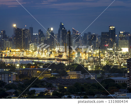 Night view of Bangkok, Thailand's skyscrapers and industrial areas along the Chao Phraya River 131980434