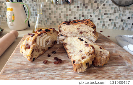 Homemade bread on wooden board with walnuts and raisins. Food and organic products. Hobbies and cooking in kitchen. 131980437