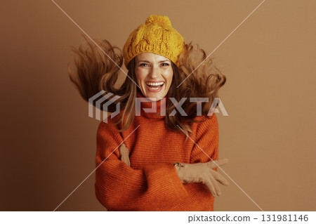 Woman Laughing with Windswept Hair in Autumn Wear 131981146