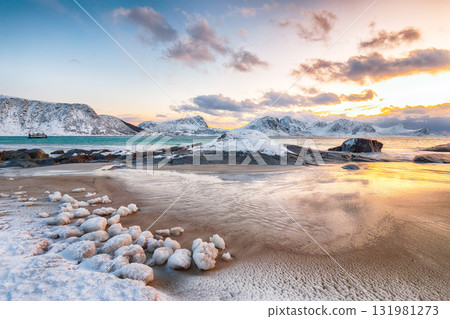 Amazing winter view of Vik beach during sunset with lots of snow and snowy mountain peaks near Leknes. Amazing winter view of Vik beach during sunset with lots of snow and snowy mountain peaks near Leknes. 131981273