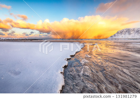 Astonishing winter scenery on Skagsanden beach with illuminated clouds during sunrise. Astonishing winter scenery on Skagsanden beach with illuminated clouds during sunrise. 131981279