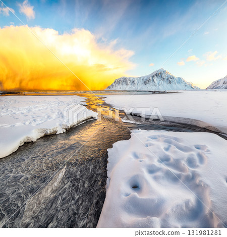 Astonishing winter scenery on Skagsanden beach with illuminated clouds during sunrise. 131981281