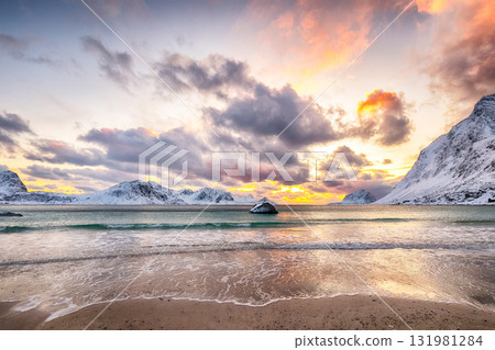 Amazing winter scenery with Haukland beach during sunset and snowy mountain peaks near Leknes. Amazing winter scenery with Haukland beach during sunset and snowy mountain peaks near Leknes. 131981284