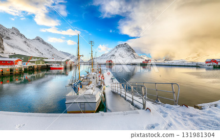Breathtaking winter sunrise over Ramberg village and harbour. Breathtaking winter sunrise over Ramberg village and harbour. 131981304