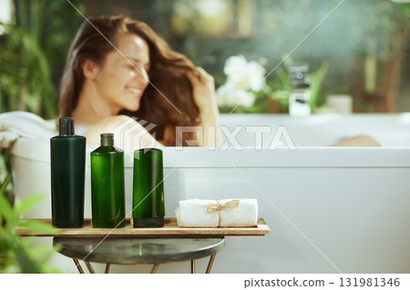 Woman Enjoying Bath with Natural Products in Spa Setting Woman Enjoying Bath with Natural Products in Spa Setting 131981346