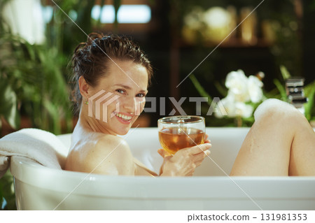 Woman Smiling and Relaxing in Her Home Spa Bath Woman Smiling and Relaxing in Her Home Spa Bath 131981353