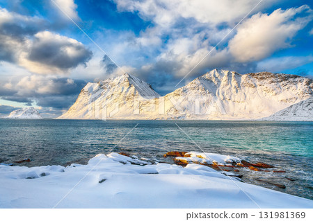 Unbelivable winter view of Vik and Haukland beaches during sunset with lots of snow and snowy mountain peaks near Leknes Unbelivable winter view of Vik and Haukland beaches during sunset with lots of snow and snowy mountain peaks near Leknes 131981369