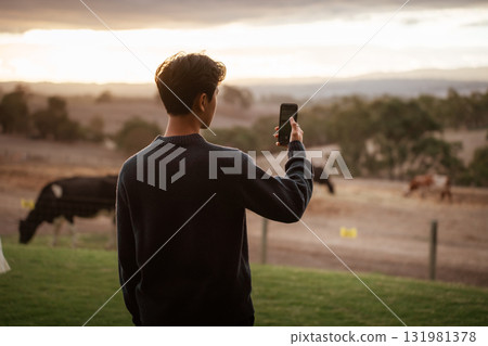 Capturing the Beautiful Sunset Moment in Nature with a Smartphone Camera Capturing the Beautiful Sunset Moment in Nature with a Smartphone Camera 131981378