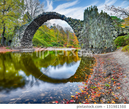 Amazing autumn landscape in Kromlau Rhododendron Park . Rakotz Bridge (Rakotzbrucke, Devil's Bridge) 131981388