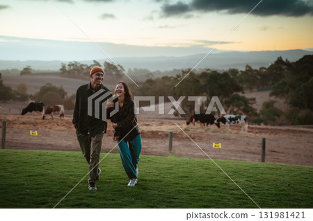 Couple Enjoying a Romantic Stroll in a Scenic Pastoral Setting 131981421