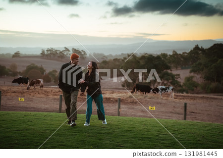 A Loving Couple Enjoying a Romantic Stroll Together at Dusk on a Beautiful Farm A Loving Couple Enjoying a Romantic Stroll Together at Dusk on a Beautiful Farm 131981445