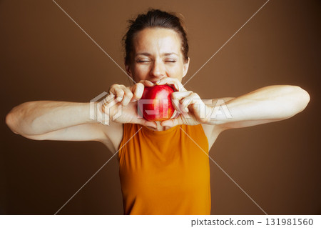 Serene Woman Anticipates a Healthy Apple Bite 131981560