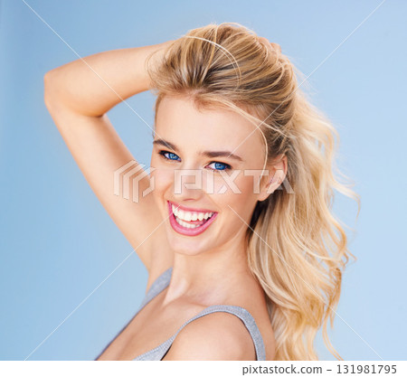 Hair, portrait and woman with smile, beauty and cosmetic treatment with hairstyle isolated on blue background. Haircare, happiness and keratin treatment with female model in studio and cosmetology Hair, portrait and woman with smile, beauty and cosmetic treatment with hairstyle isolated on blue background. Haircare, happiness and keratin treatment with female model in studio and cosmetology 131981795