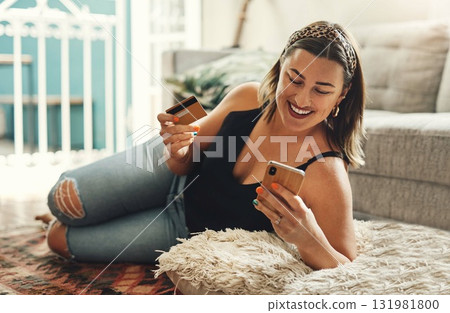 Phone, credit card and woman on floor for online shopping, e commerce and fintech payment, loan or finance at home. Happy person relax on carpet, typing and internet banking on mobile app transaction Phone, credit card and woman on floor for online shopping, e commerce and fintech payment, loan or finance at home. Happy person relax on carpet, typing and internet banking on mobile app transaction 131981800