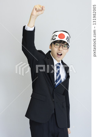 A man in a suit wearing a victory headband 131982005