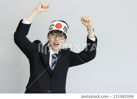 A man in a suit wearing a victory headband 131982006