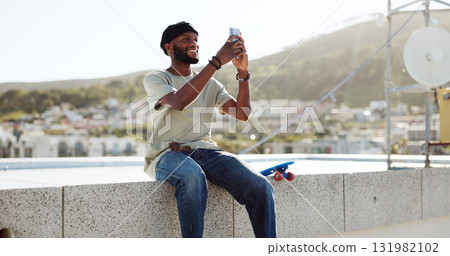 Black man, selfie on rooftop and social media post, memory while at skate park with app and happy outdoor. Influencer, content creation and smile in picture with cityscape, trendy skater and travel Black man, selfie on rooftop and social media post, memory while at skate park with app and happy outdoor. Influencer, content creation and smile in picture with cityscape, trendy skater and travel 131982102
