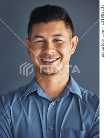 Face portrait, smile and business man in studio isolated on a blue background. Ceo, boss goals and happy, confident and proud male entrepreneur from Brazil with vision, mission and success mindset. 131982235