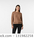 Young woman with long dark hair in a brown cashmere sweater and black jeans on a white background 131982258