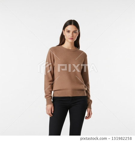 Young woman with long dark hair in a brown cashmere sweater and black jeans on a white background 131982258