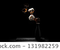 Backlit cotton branch with fluffy white bolls in a black vase for a minimalist still life 131982259