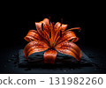 Beautiful single orange tiger lily flower with water drops on a wet slate stone in the dark 131982260