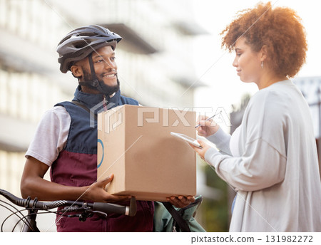 Black man, box and tablet in delivery service, package or parcel for female customer order in city. Happy African American male courier employee delivering cargo to woman with touchscreen signature 131982272
