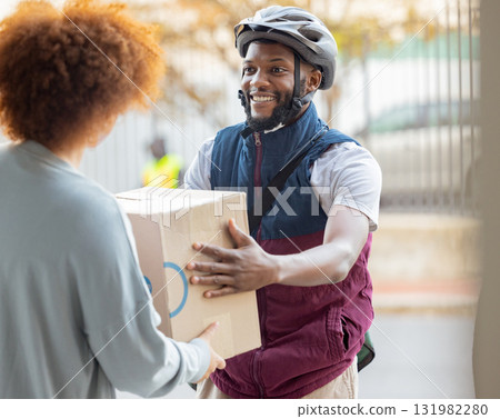 Black man, smile and delivery with box for woman at house for logistics, cargo and safety. Young african courier, package and shipping service with stock, helmet and e commerce job in neighborhood 131982280