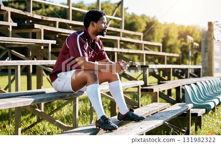 Rugby, sports or black man on pavilion thinking of training, exercise or workout game on grass field. Wellness, focus or African athlete with a vision, motivation or fitness goals sitting on a bench Rugby, sports or black man on pavilion thinking of training, exercise or workout game on grass field. Wellness, focus or African athlete with a vision, motivation or fitness goals sitting on a bench 131982322