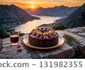 Montenegrin fig and walnut cake with red wine during a beautiful sunset over a mountain bay 131982355
