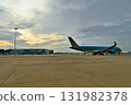 An airplane illuminated by the sunset 131982378
